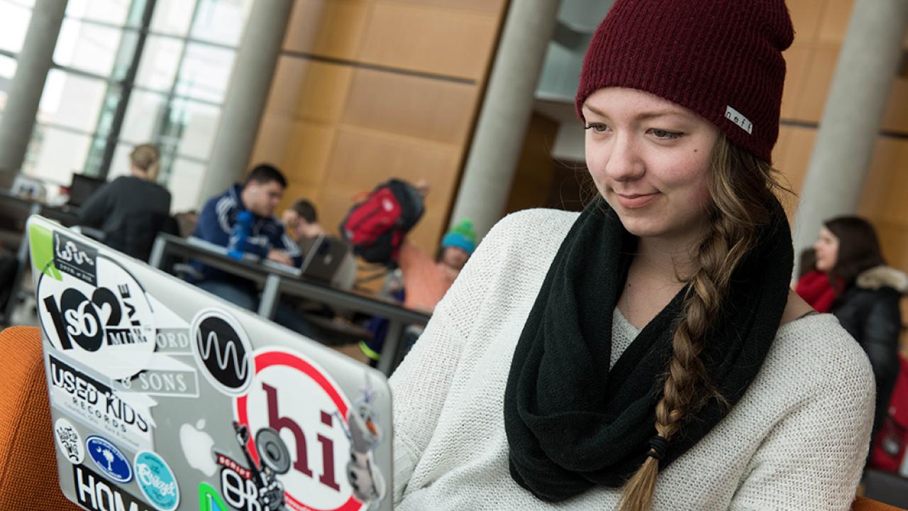 Ohio State student working on laptop in Thompson Library.